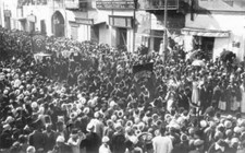 Crowds gather watch a procession marching through an Egyptian town Old Photo