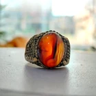 Sterling silver ring with a Yemeni agate charm in shades of brown, translucent.