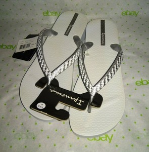 white and silver flip flops