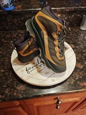 This is a Merrell Moab Speed GORE-TEX hiking shoe in a black and gold/tan color