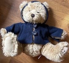 Fao Schwarz 2009 plush bear in orginal blue coat with bear head buttons.