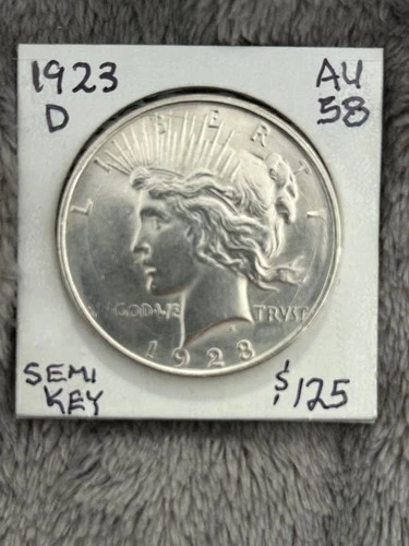 A/UNC 1923-D SILVER PEACE DOLLAR. Looks Choice BU with perfect rims.