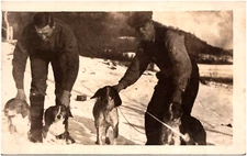 Hunters with a Pack of Eager Hound Dogs in Snow 1920s RPPC Postcard Photo