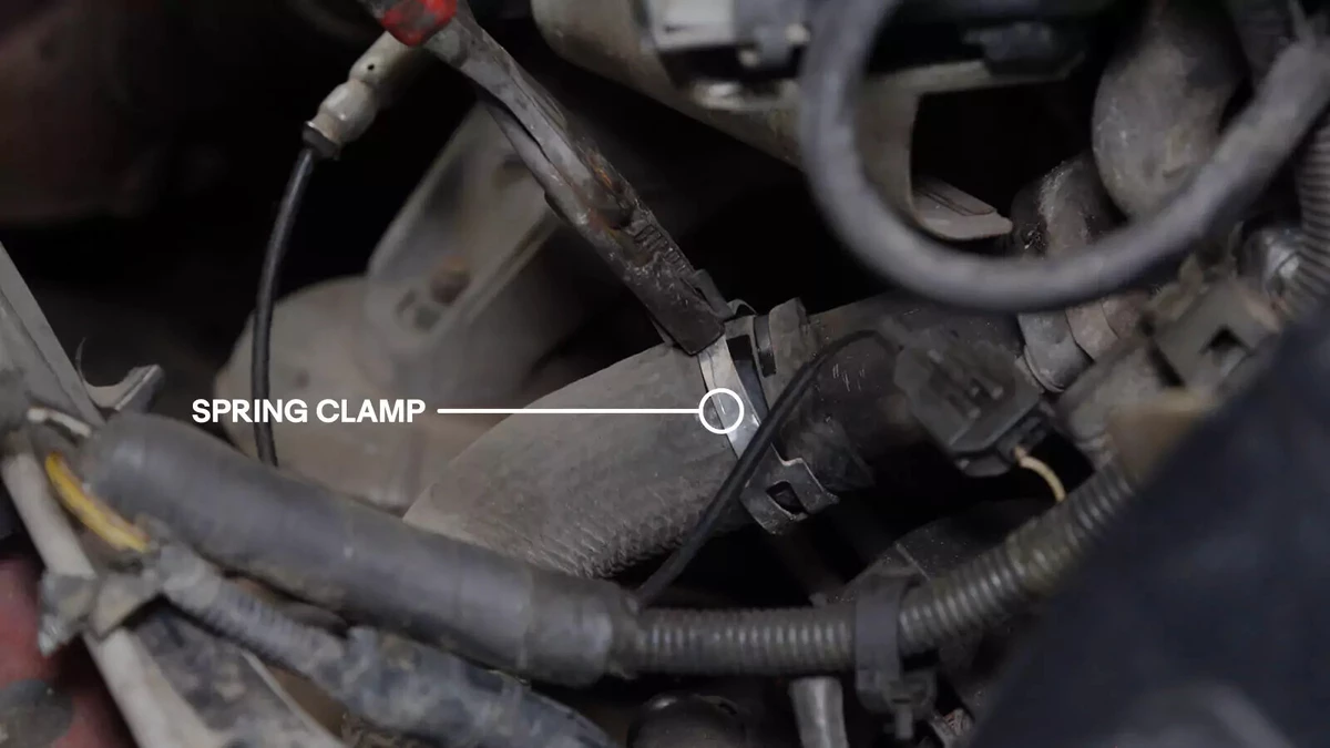 An arrow pointing to a radiator’s spring clamp.