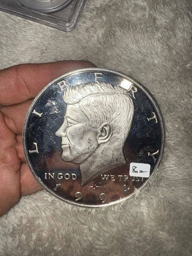 8 Troy ounce Kennedy Half Dollar.  .999 silver,  3.5 inch diameter.