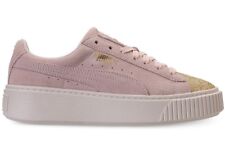 pink pumas with gold writing