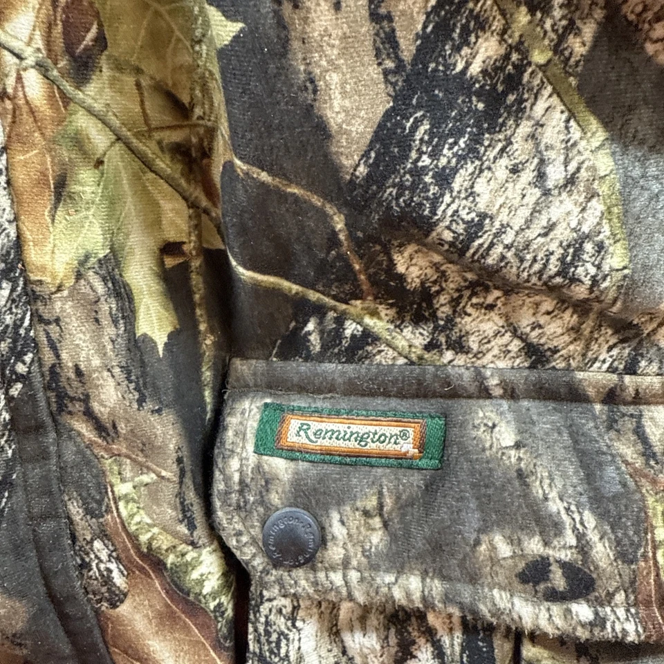 Chaqueta con Capucha Remington Mossy Oak Camuflada Juvenil 16/18 Aislada A Presionada Foto 2 de 4