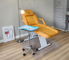 med spa chair or tattoo chair. Orange. Comes with matching stool.