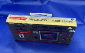 Nintendo Game and Watch Super Mario Bros Electronic Handheld In Hand.