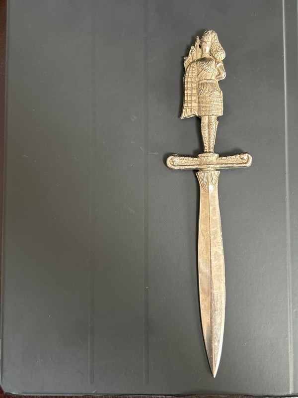 vintage envelope opener with man playing bagpipes.