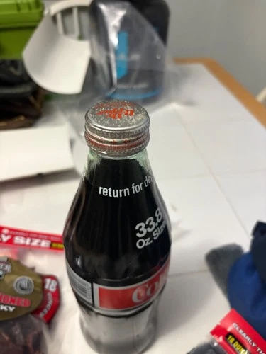 vintage unopened coca cola bottle with Dr. Pepper lid