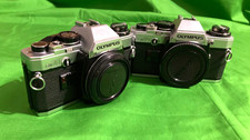 TWO 2 Olympus OM 10 SLR 35 mm Cameras for parts See description READ