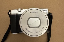 Nikon 1 J5 Silver 20.8MP Mirrorless Digital Camera w/10-30mm PD-ZOOM Lens - USED
