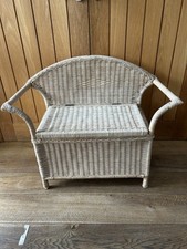 This versatile piece of furniture is a woven rattan or wicker storage bench