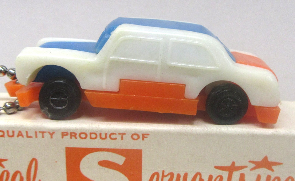 Mint-in-box vintage Hong Kong 'Mechanical Servants' car dexterity keychain puzzle — the holy grail condition for this obscure pocket toy genre.