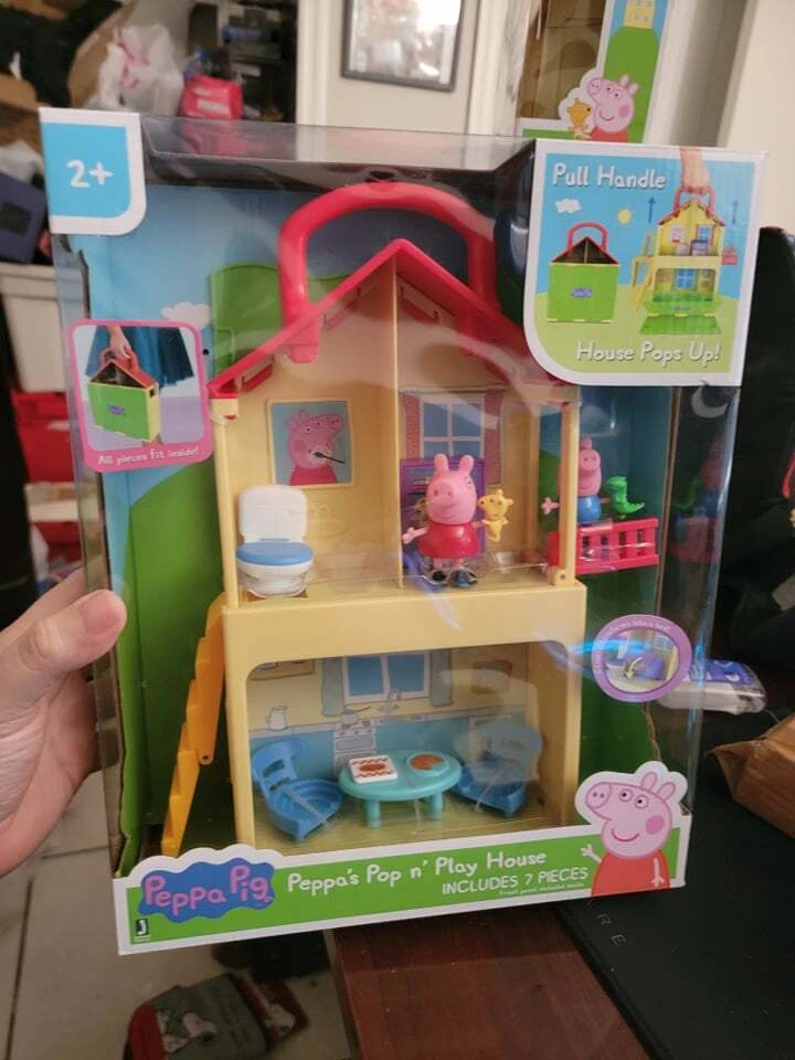 A plastic Peppa Pig toy play house standing on a table Stock Photo