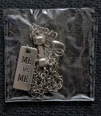 ME VS ME PENDANT WITH DUMBELL SILVER COLORED METAL SEALED