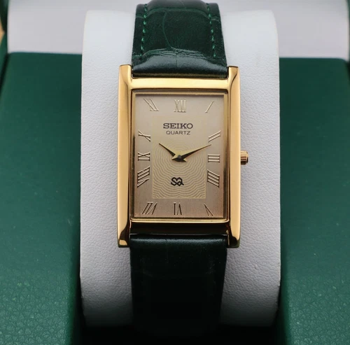 Vintage Seiko Slim Quartz Men's Wrist Watch Gold Dial with Green Strap.