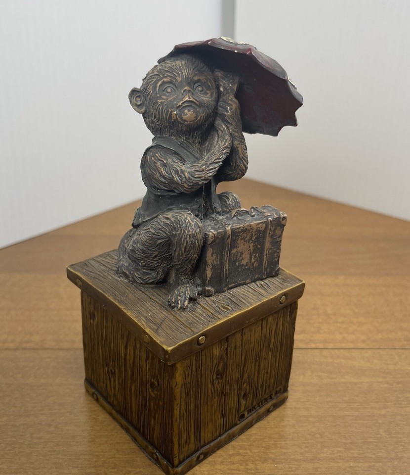 A charmingly hand-painted trinket box depicting a little traveling monkey with umbrella and suitcase — the kind of whimsical vintage keepsake that feels genuinely one-of-a-kind.