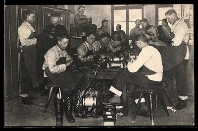 Postcard soldiers cleaning guns and packing knapsacks 1909 