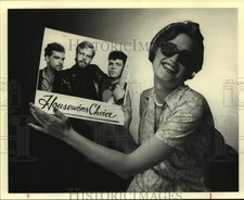 Press Photo Woman displays record of the band Housewives Choice - sap14289