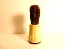 older shaving brush with a black and off-white plastic handle; marked Rubberset