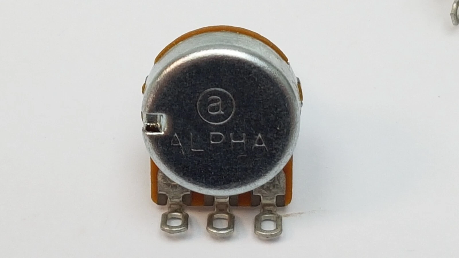 Alpha logo on the metal case of a B50K potentiometer, three solder lugs