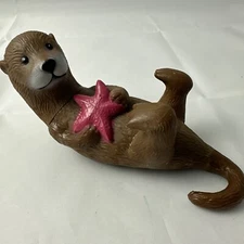 Ankyo Otter hard plastic figure holding a starfish lying on back 6" long 