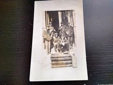 Group of men with Steamer trunk Suitcase Men In Doorway RPPC Photo Postcard