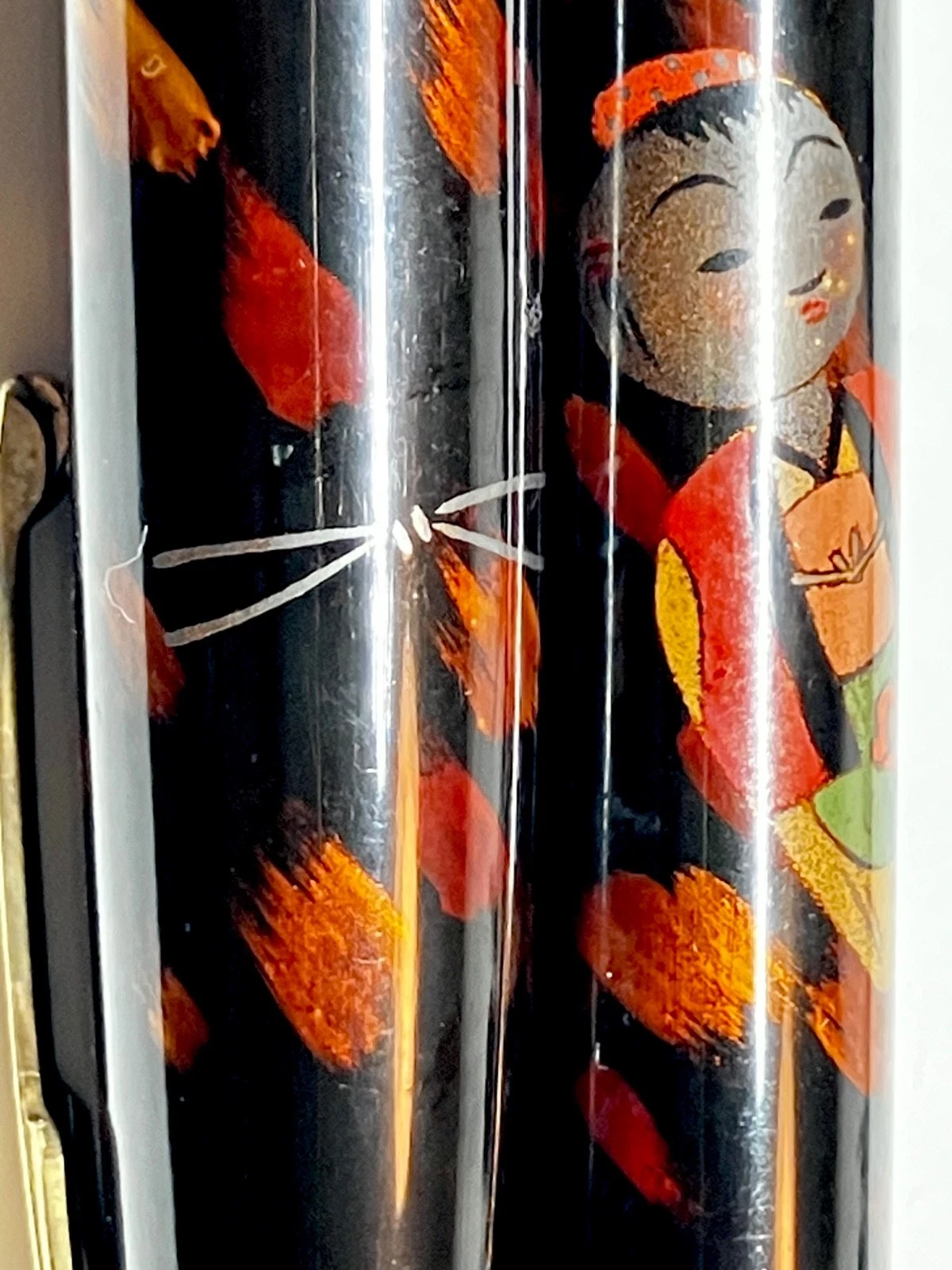 Vintage ink shut off fountain pen with red and orange kokeshi figure design on black barrel, Haruyama made urushi maki-e.