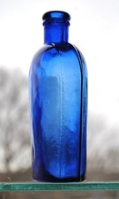 STRAPSIDED WHISKEY FLASK: deep cobalt blue strapsided half-pint size flask,