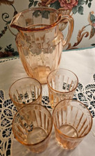 Pink Depression Glass Pitcher with four glasses.