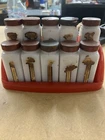 GRIFFITH SPICE JARS, 10 MILK GLASS BOTTLES, RED PLASTIC RACK