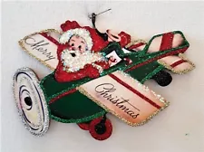 SANTA CLAUS in GREEN AIRPLANE w/ TOYS * Glitter CHRISTMAS ORNAMENT * Vtg Img