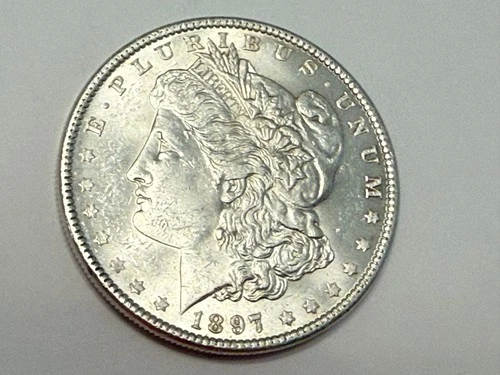1897 Morgan U.S. silver dollar. Nice satin white BU. #em1