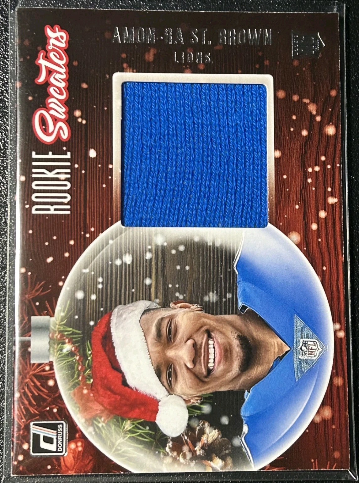 Amon-Ra St. Brown Panini Donruss Rookie Holiday Sweater Memorabilia #RSASB Base