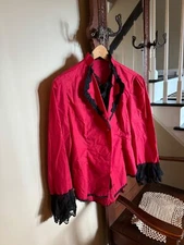 VICTORIAN STYLE RED JACKET WITH BLACK TRIM HIGH/LOW IN EXCELLENT USED CONDITION
