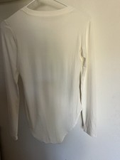Women NWOT "Unbranded" white long sleeve bodysuit. Size M.