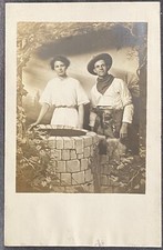 STUDIO REAL PHOTO RPPC~Woman & Man in Cowboy Costume w Wooly Chaps Near Well