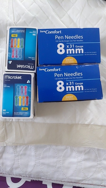 SureComfort Pen Needles and two boxes of Microlet Colored Lancets.