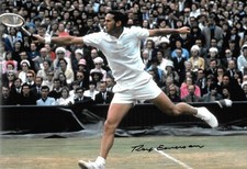 roy emerson returns shot at the net during the final on grass signed 12x8 photo