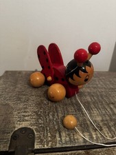Vintage wooden pull-along ladybug toy.