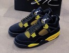 Nike Air Jordan 4 Thunder Black and yellow colorway, versatile and non-slip bask