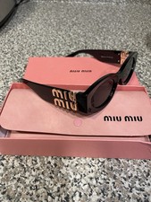 Miu Miu Women s Black Cat Eye Logo Temple Sunglasses, Black Tinted Lenses
