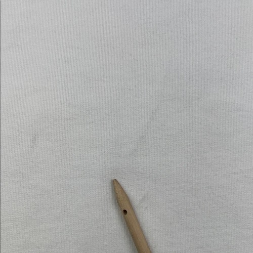 White 100% cotton funnel neck capelet with faint wrinkles, shown flat beside a wooden sewing pin.