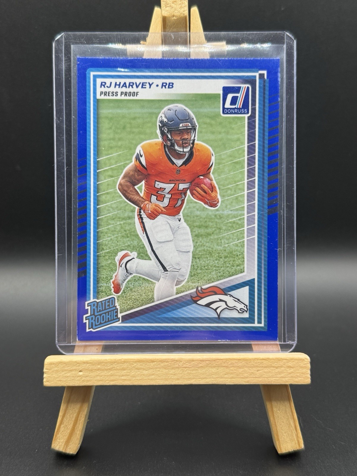 2025 Panini Donruss RJ Harvey Rated Rookie Press Proof Blue #312 Denver Broncos
