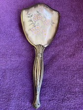 Vintage hairbrush with ornate golden handle and pink floral design