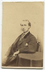 MAN SEATED AT TABLE, WEARING OVER COAT/VELVET COLLAR. CDV, BOSTON, MASS.
