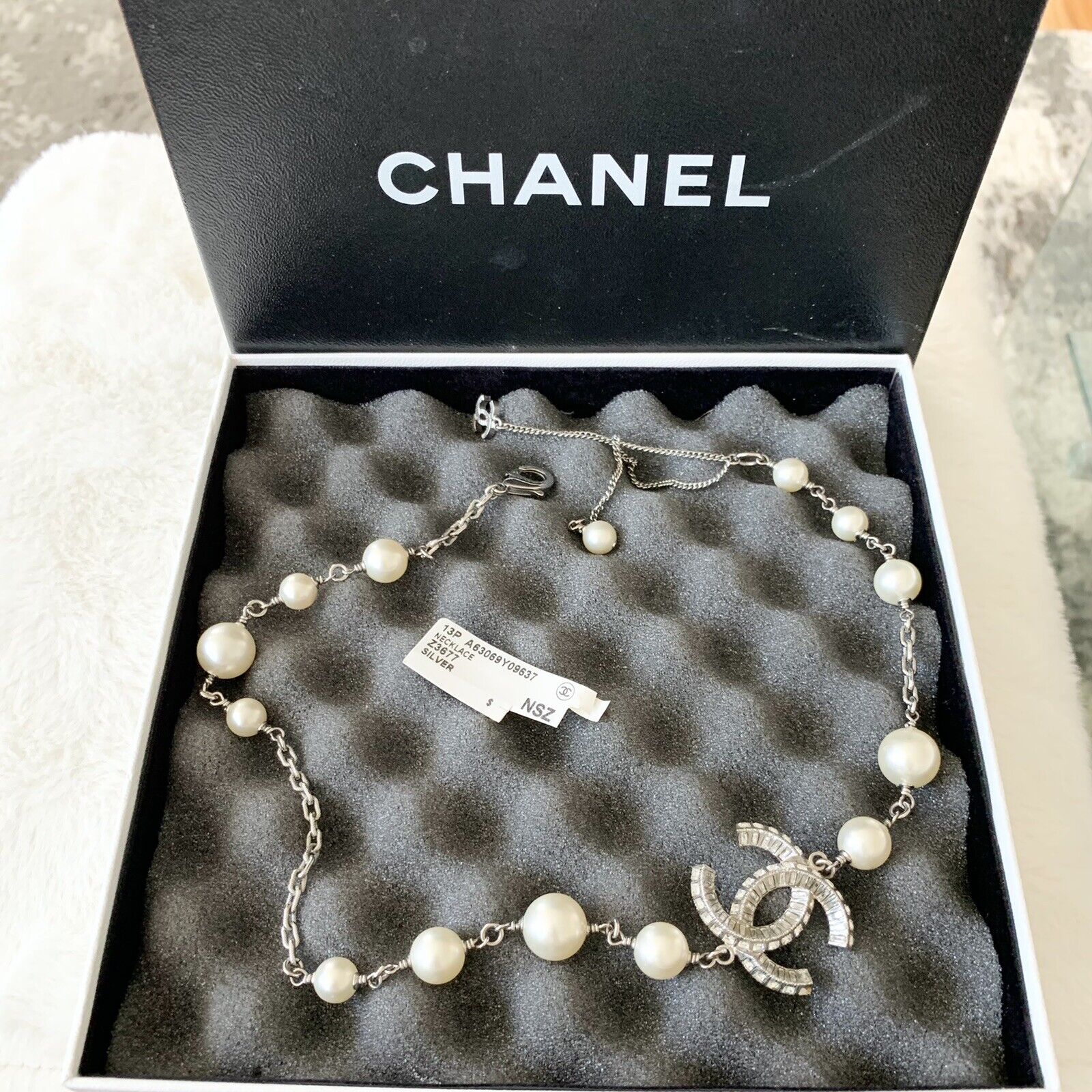 An Authentic Chanel Long Pearl Necklace with CC logos with Seed Pearls and  Crystals in original Box