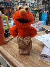 This is a vintage 2002 Fisher-Price Elmo "Potato Sack Racer" plush